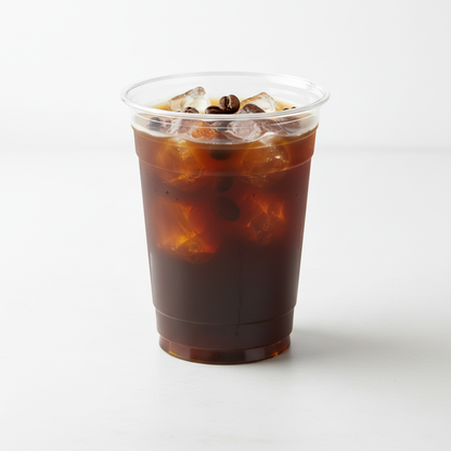 Vaso cónico transparente 16 oz con café helado, hielo y granos de café